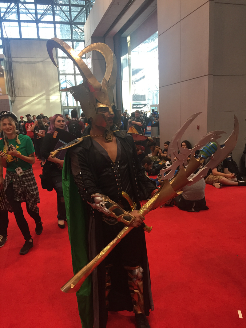 Loki shows off his staff.